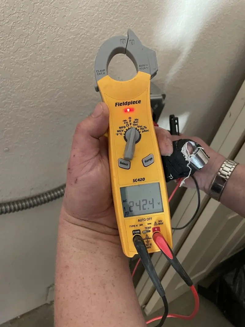 Voltage testing with clamp meter during Outlet Installation in Westfall